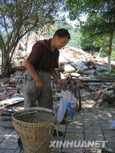 7月5日，北川縣城的一位居民在縣城內(nèi)尋找自己的物品。當(dāng)日，記者經(jīng)特許進(jìn)入地震重災(zāi)區(qū)北川縣城采訪，用相機(jī)記錄下北川縣城的現(xiàn)狀。 